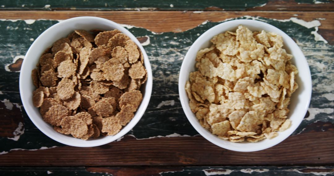 Healthy Whole Grain and Corn Flakes Cereals in Bowls on Wooden Table - Free Images, Stock Photos and Pictures on Pikwizard.com