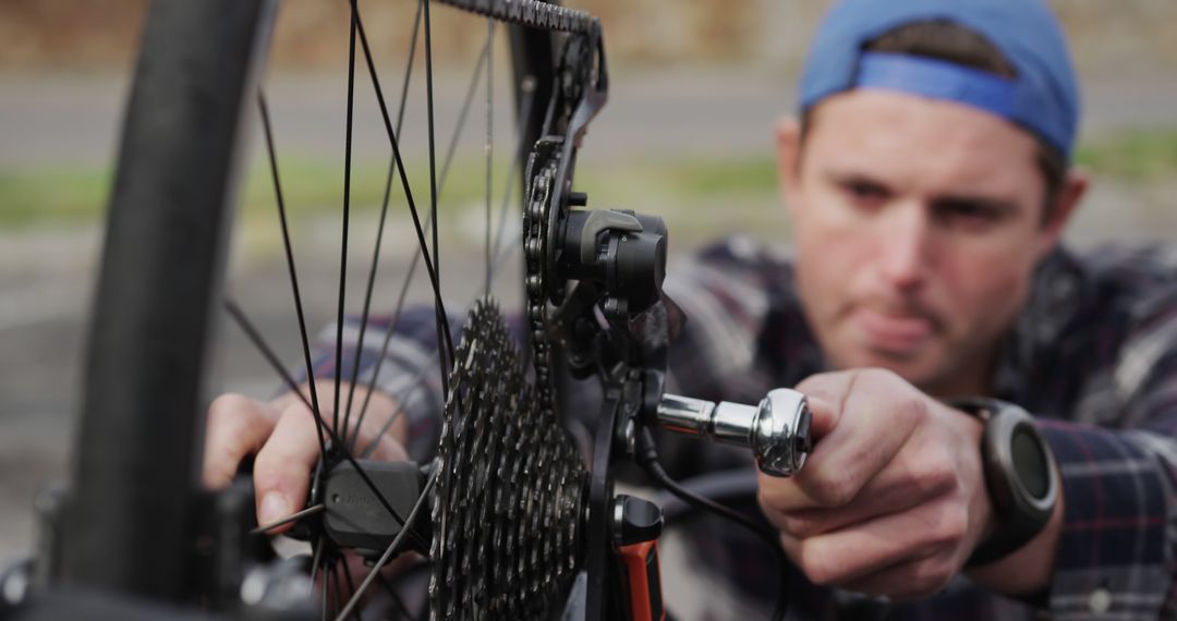 Man Repairing Bicycle Gear Outdoors - Free Images, Stock Photos and Pictures on Pikwizard.com