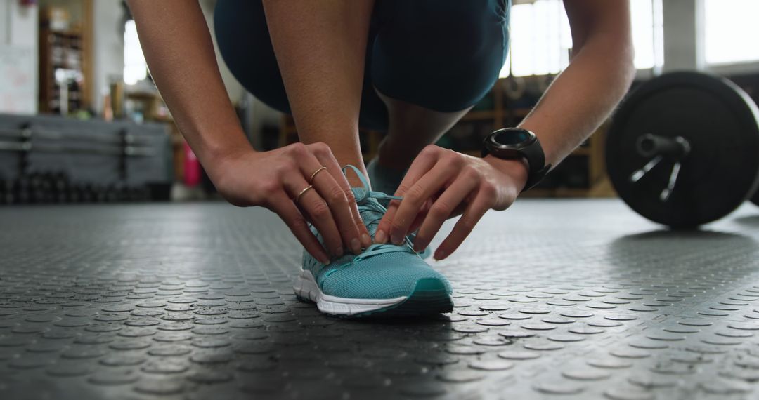 Close-Up of Person Tying Shoe in Gym - Free Images, Stock Photos and Pictures on Pikwizard.com