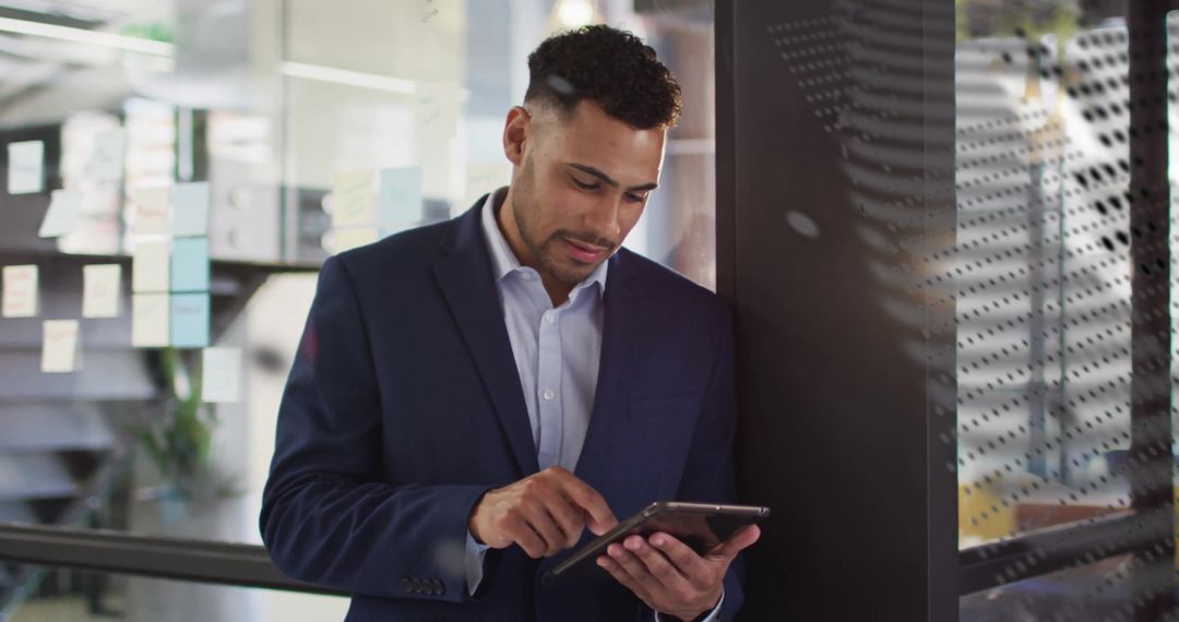 Businessman Analyzing Data on Tablet