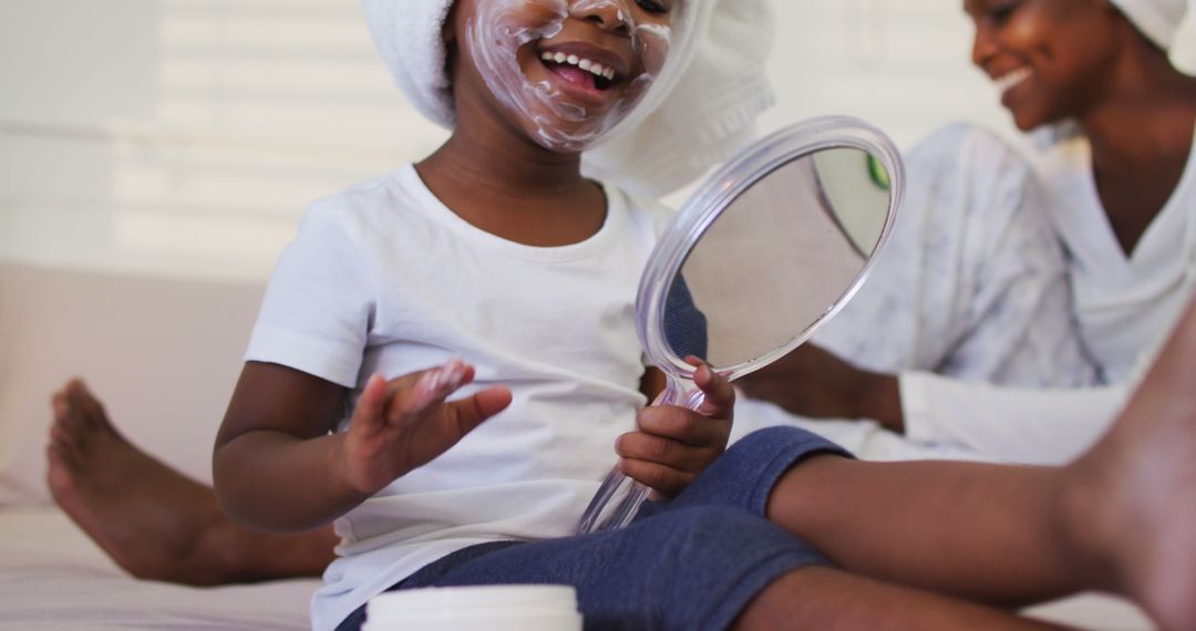 Joyful Child Enjoying Skincare Routine with Parent at Home - Free Images, Stock Photos and Pictures on Pikwizard.com