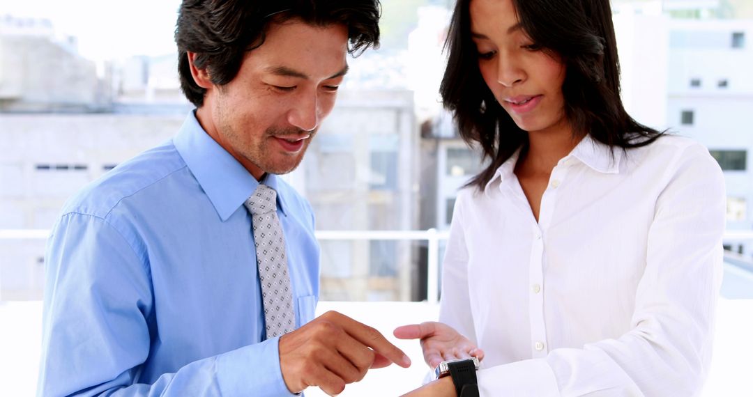 Business Professionals Discussing Smart Watch Features