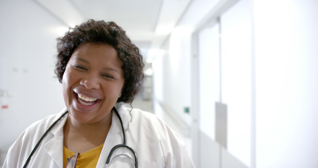 Smiling Nurse in Hospital Hallway with Stethoscope - Free Images, Stock Photos and Pictures on Pikwizard.com