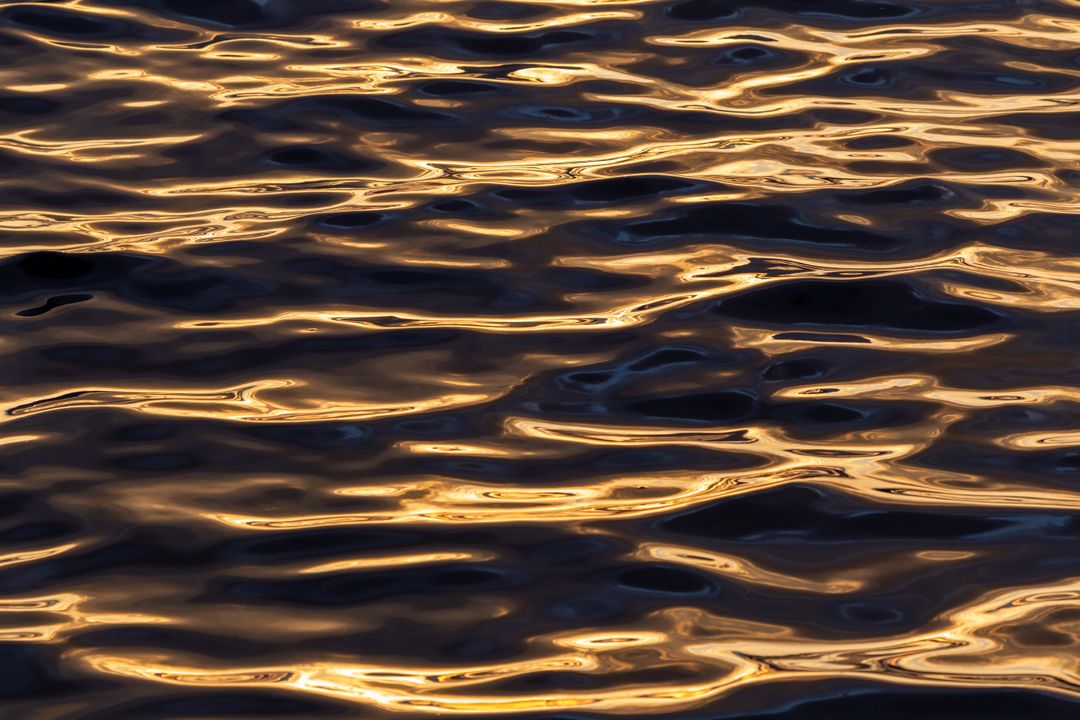 Golden Hour Ripples on Dark Water Abstract Shimmering Sunset Reflections Pattern
