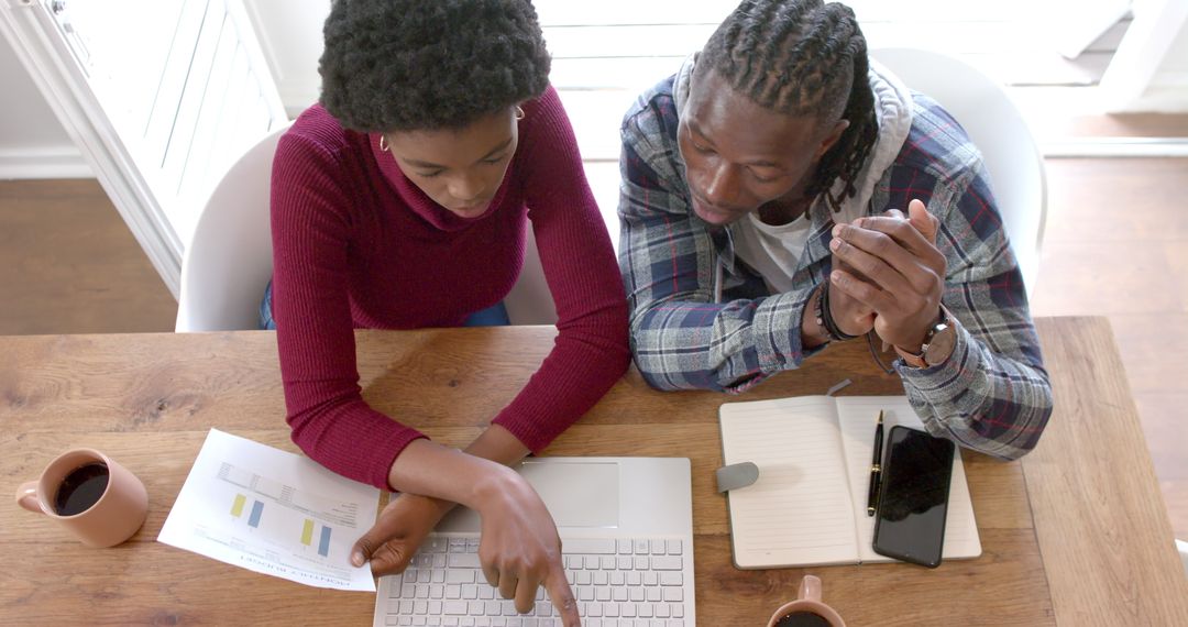 Two Colleagues Collaborating at Laptop in Home Office