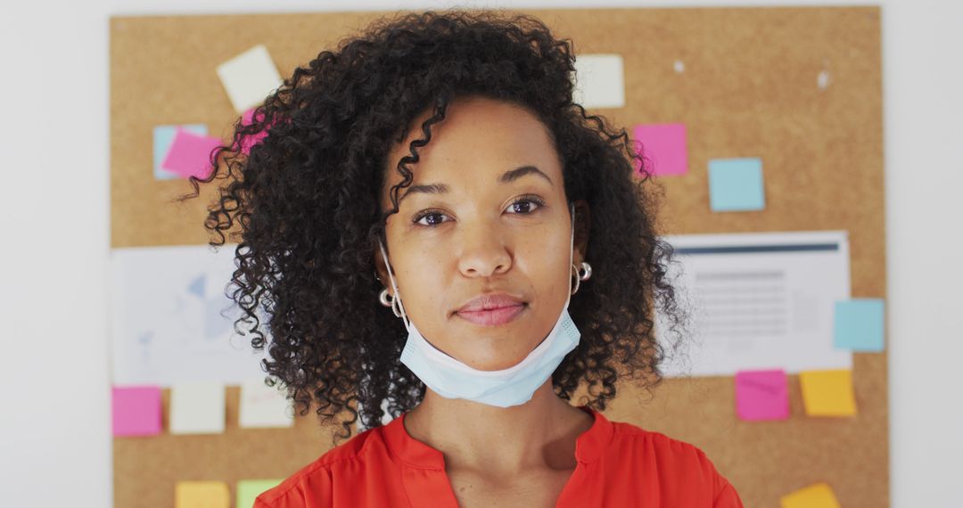 Confident African American Woman Removing Face Mask in Office - Free Images, Stock Photos and Pictures on Pikwizard.com