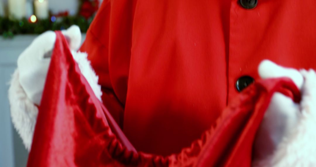 Santa Claus Holding Red Gift Sack in Christmas Setting - Free Images, Stock Photos and Pictures on Pikwizard.com