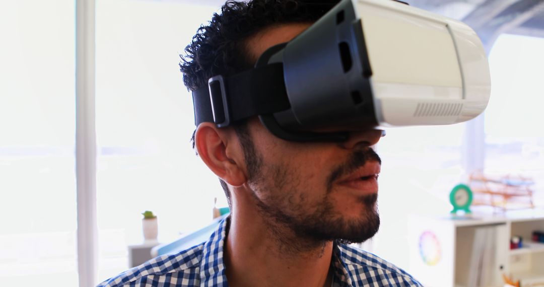 Man Using Virtual Reality Headset in Bright Office Environment - Free Images, Stock Photos and Pictures on Pikwizard.com