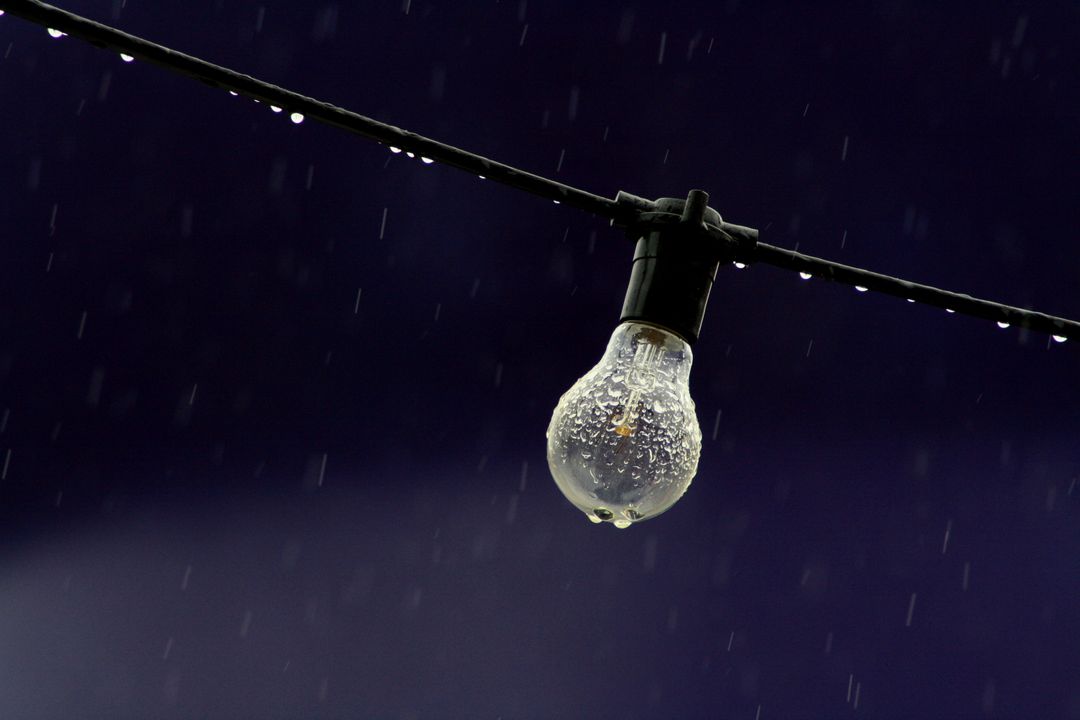 Vintage Light Bulb Hanging in Rainy Night - Free Images, Stock Photos and Pictures on Pikwizard.com