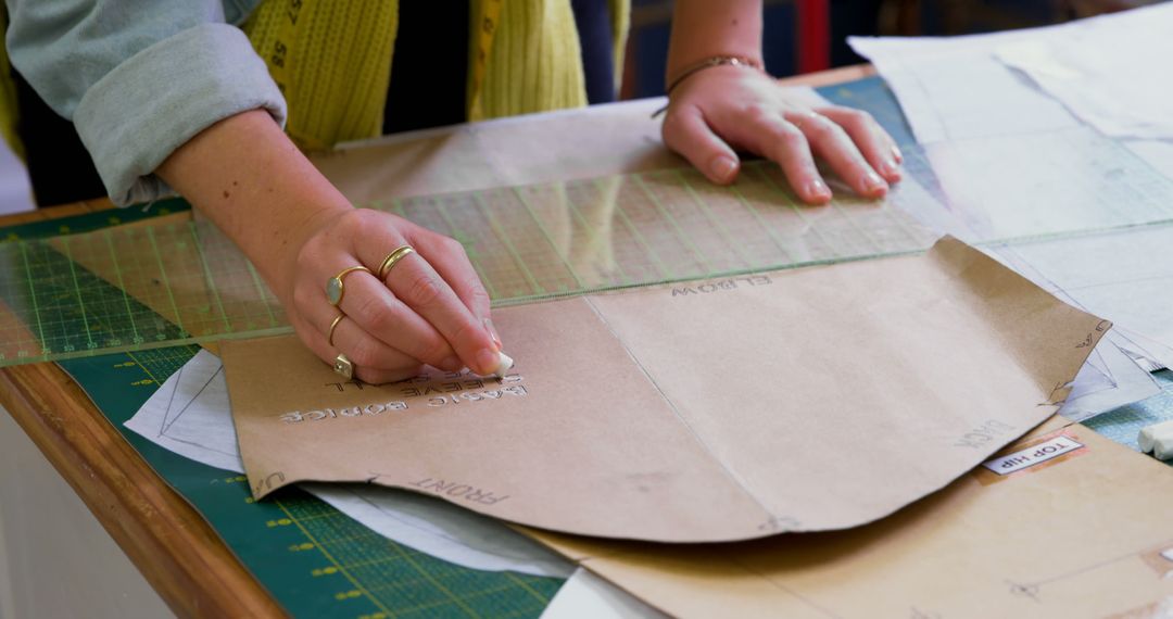 Fashion Designer Creating Garment Pattern on Worktable - Free Images, Stock Photos and Pictures on Pikwizard.com