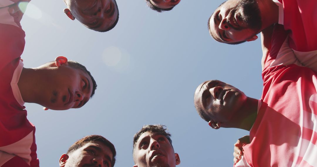 Football Team in Huddle Looking Up at Clear Blue Sky - Free Images, Stock Photos and Pictures on Pikwizard.com