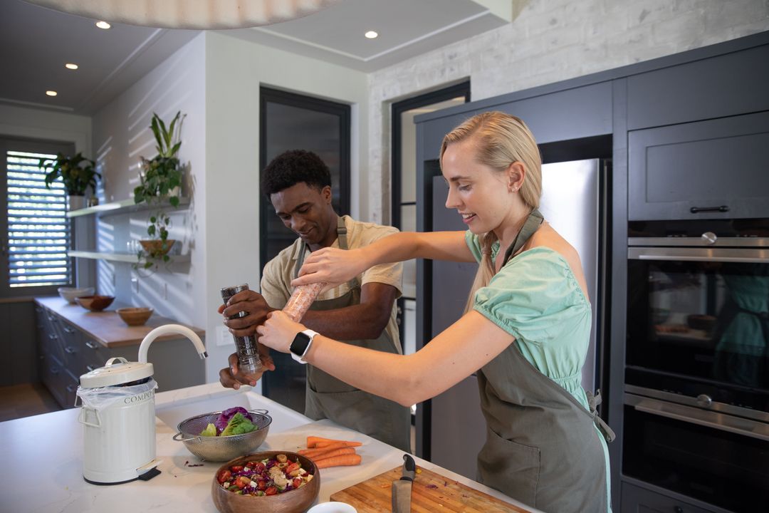 Couple Seasoning Salad in Modern Minimalist Kitchen