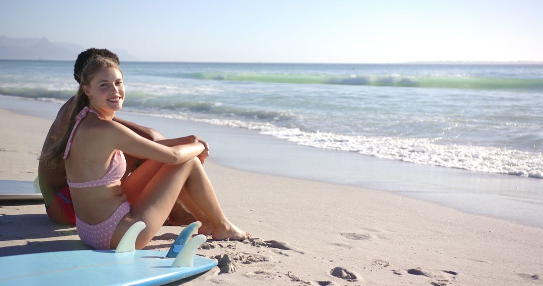 Woman Relaxing on Surfboard at Beach with Ocean View
