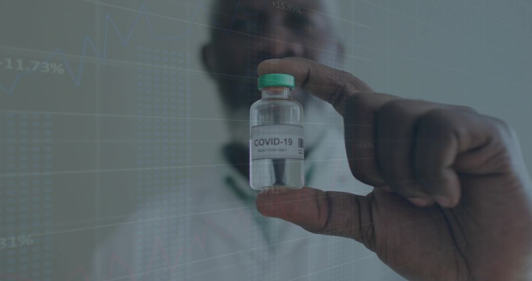 Holding COVID-19 vaccine vial with data overlay for research and healthcare analytics