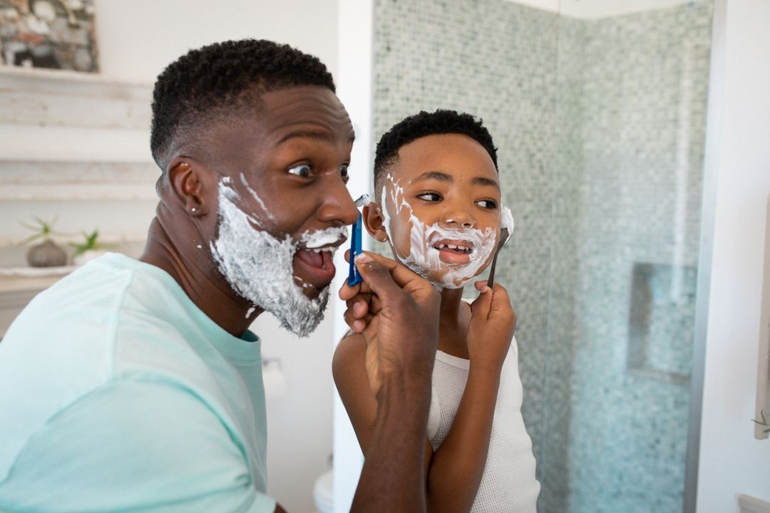 African American Father and Son Shaving Together in Bathroom - Free Images, Stock Photos and Pictures on Pikwizard.com