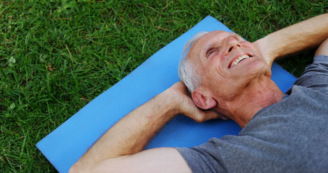 Senior Man Relaxing on Exercise Mat Outdoors - Free Images, Stock Photos and Pictures on Pikwizard.com