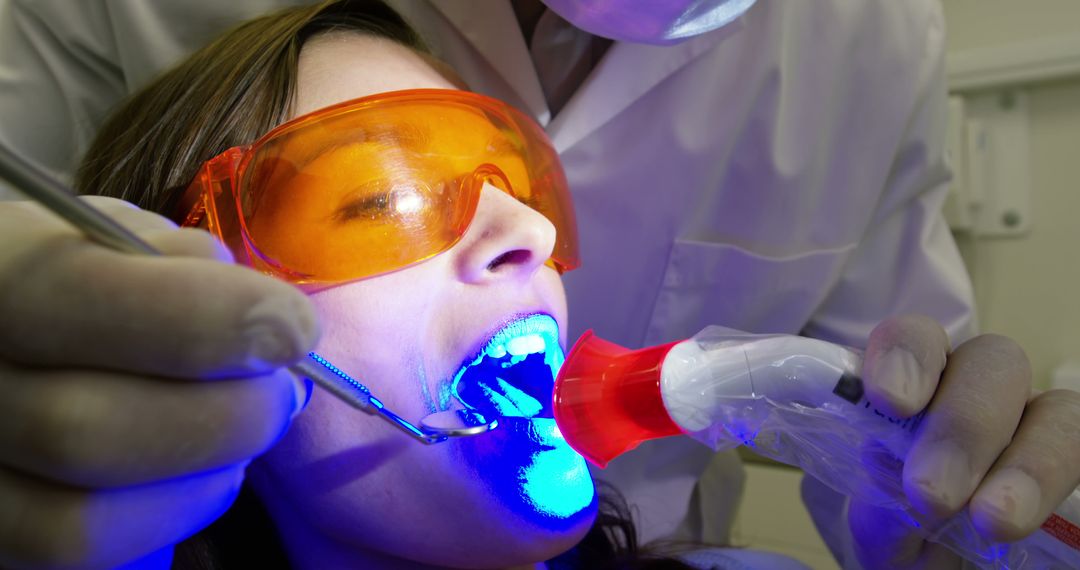 Dentist Whitening Teeth with UV Light on Patient in Clinic - Free Images, Stock Photos and Pictures on Pikwizard.com