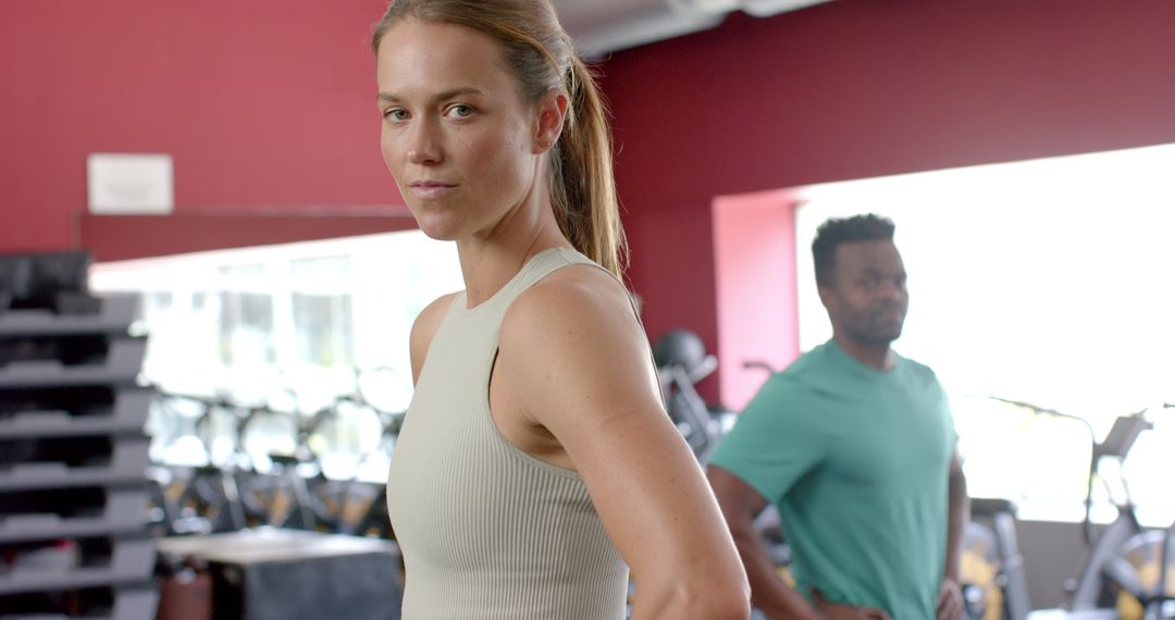 Diverse Athletes Focused on Fitness in Modern Gym Environment