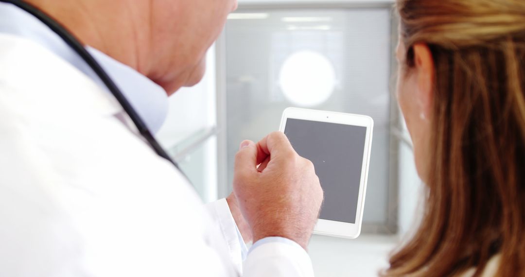 Medical Professional and Patient Discussing Digital Chart on Tablet - Free Images, Stock Photos and Pictures on Pikwizard.com