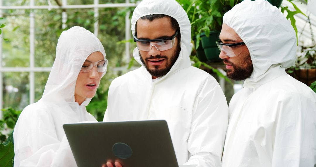 Scientists Analyzing Data on Laptop in Greenhouse - Free Images, Stock Photos and Pictures on Pikwizard.com