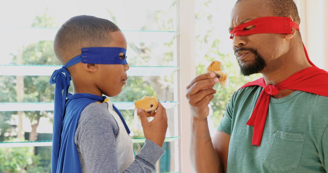 Father and Son Wearing Superhero Costumes Eating Muffins - Free Images, Stock Photos and Pictures on Pikwizard.com