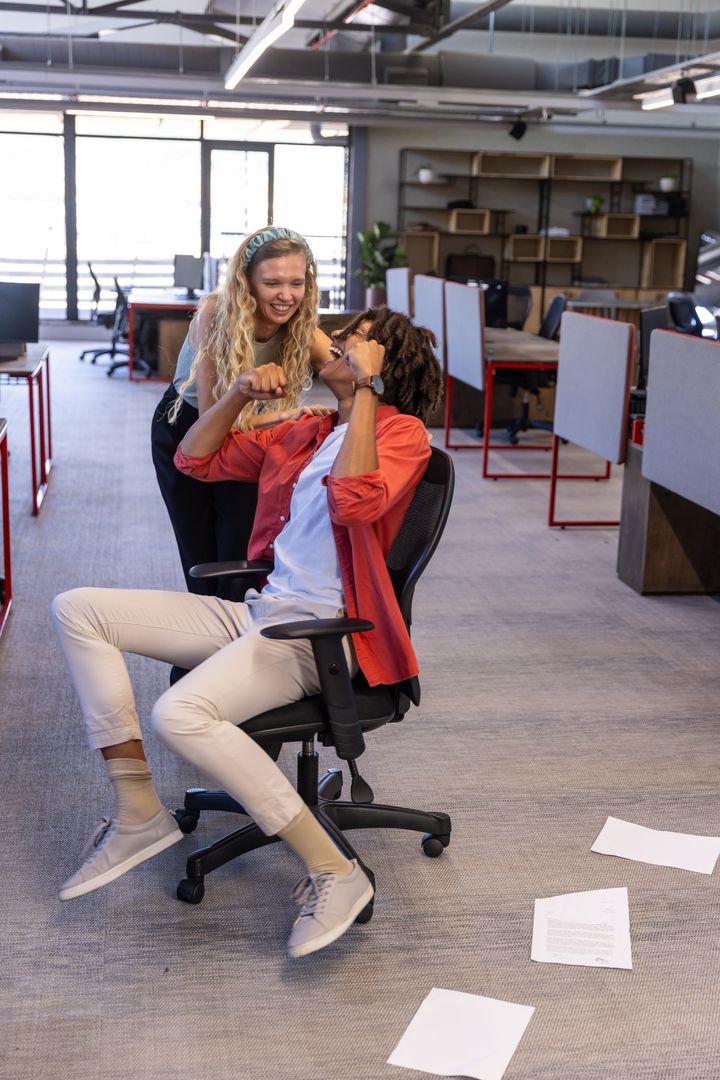 Dynamic Coworkers Celebrating Success in a Modern Office Environment