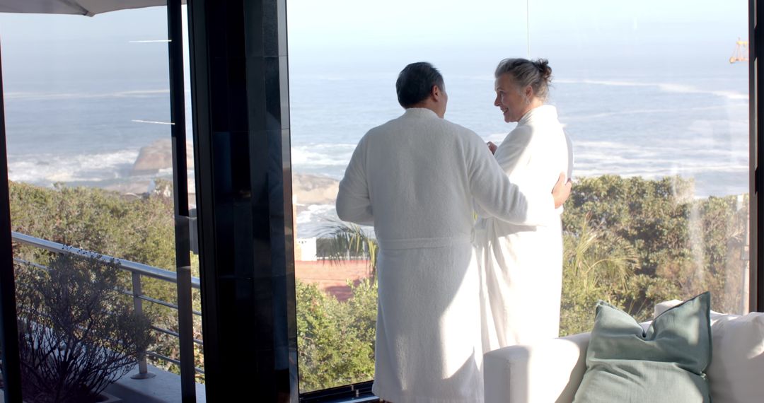 Senior Couple Embracing Scenic Ocean View in Luxury Resort