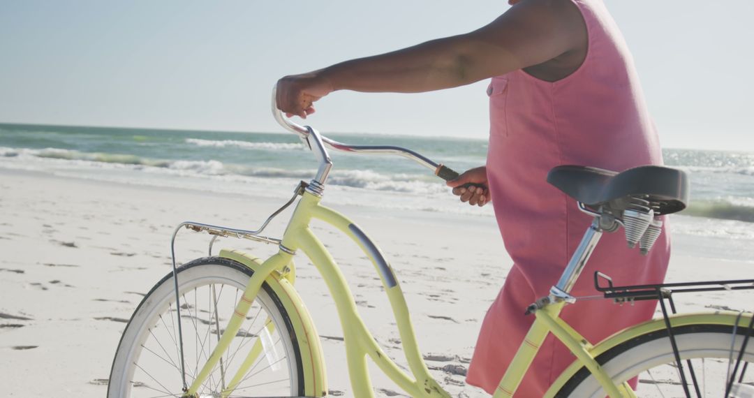 Woman Walking with Yellow Bicycle on Sunny Beach - Free Images, Stock Photos and Pictures on Pikwizard.com