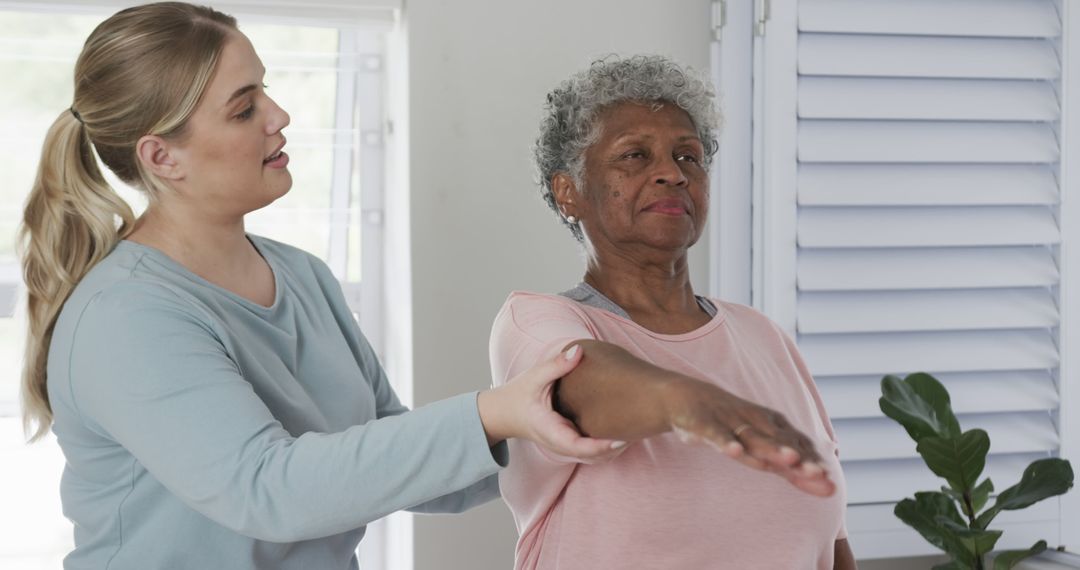 Physical Therapist Assisting Senior Woman During Rehabilitation Exercise Session - Free Images, Stock Photos and Pictures on Pikwizard.com