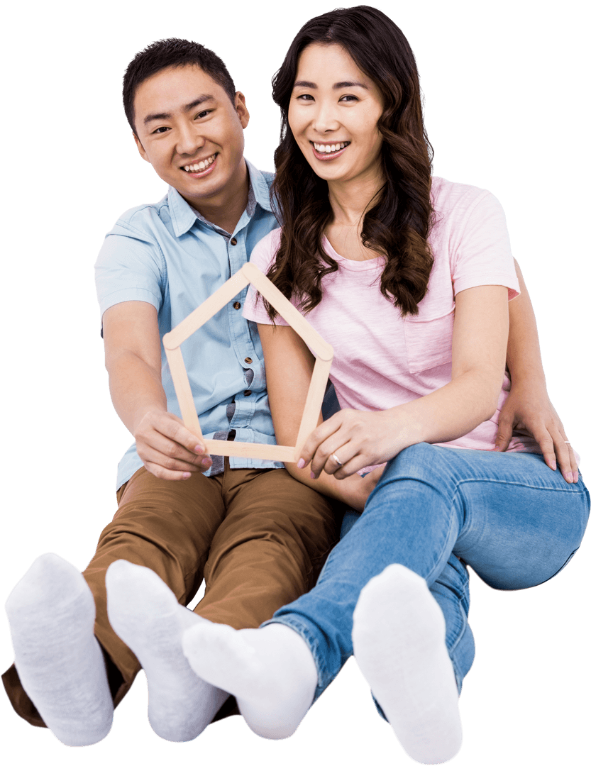 Cheerful Couple Holding Transparent House Frame Symbolizing Home Ownership