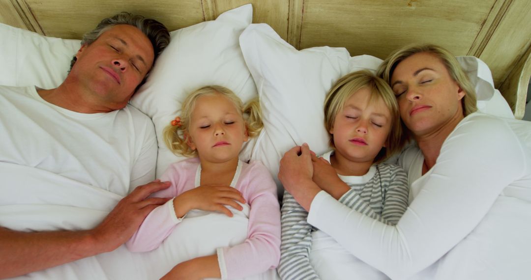 Happy Family Sleeping Soundly Together in Bed - Free Images, Stock Photos and Pictures on Pikwizard.com