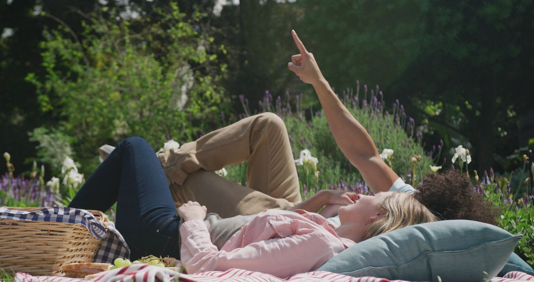 Happy Couple Relaxing During Picnic in Lush Garden
