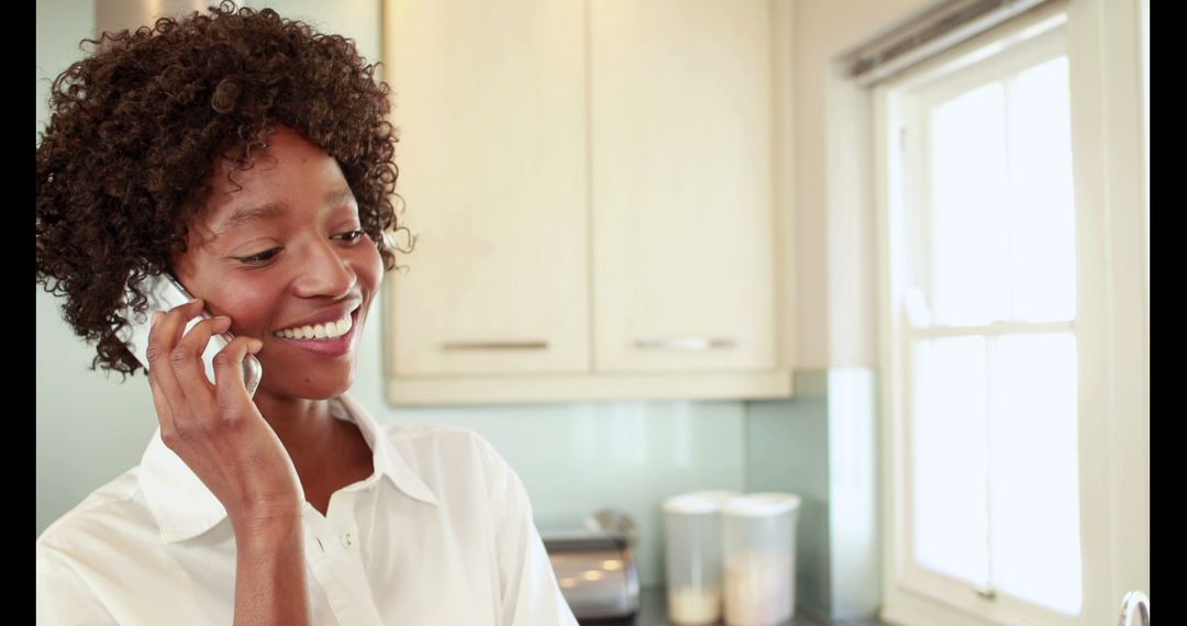 Smiling Woman Making Phone Call in Modern Kitchen - Free Images, Stock Photos and Pictures on Pikwizard.com