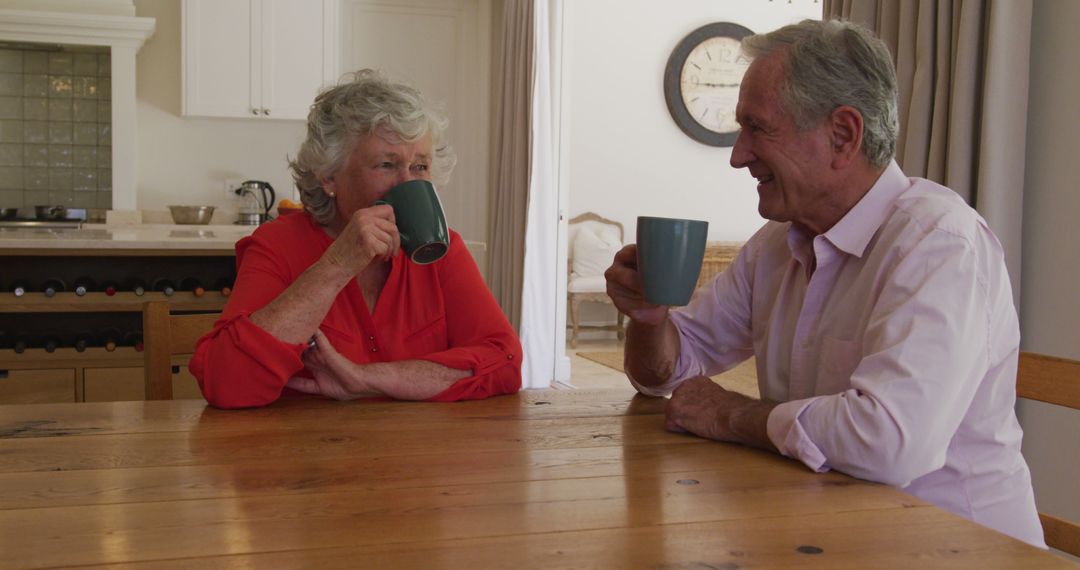 Senior Couple Enjoying Hot Drinks in Modern Kitchen - Free Images, Stock Photos and Pictures on Pikwizard.com