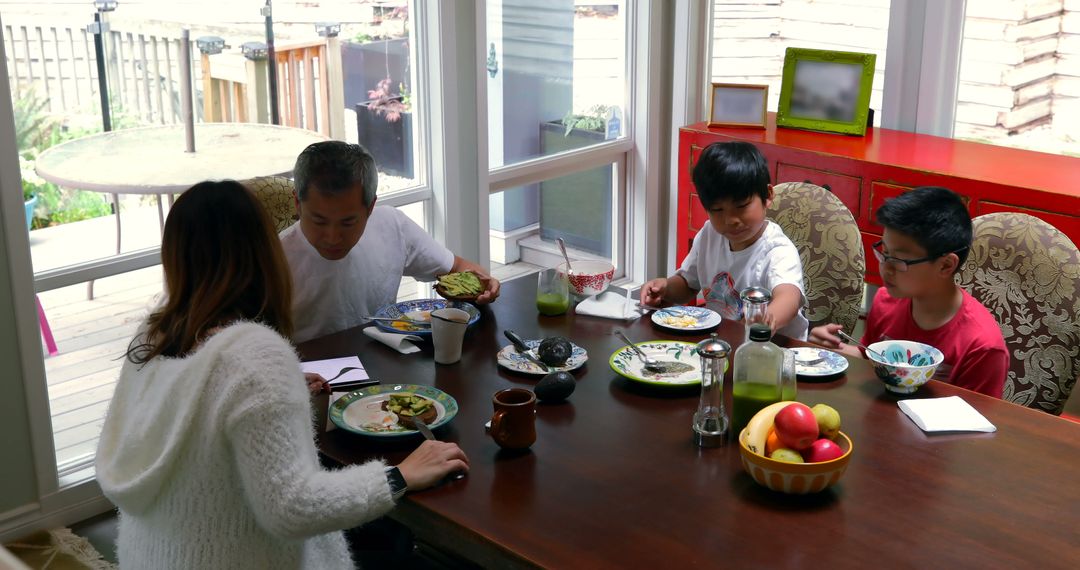 Family Enjoying Breakfast Together in Cozy Home - Free Images, Stock Photos and Pictures on Pikwizard.com