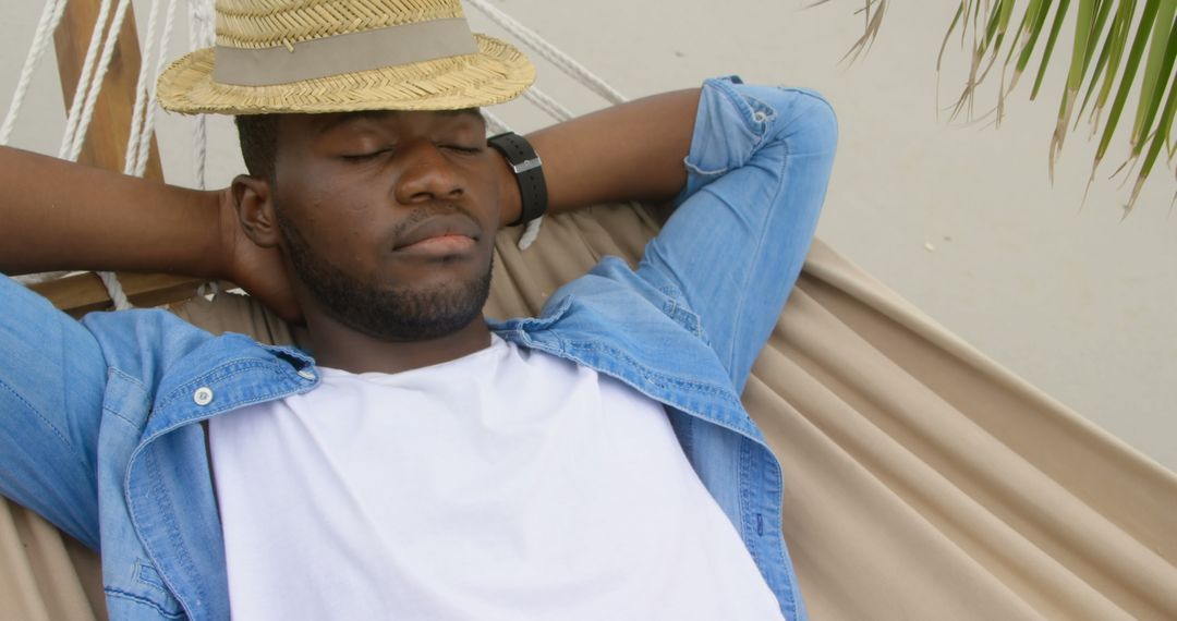 Man Relaxing in Hammock by Beachside