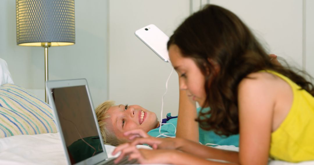 Children Using Laptops and Tablets on Bed - Free Images, Stock Photos and Pictures on Pikwizard.com