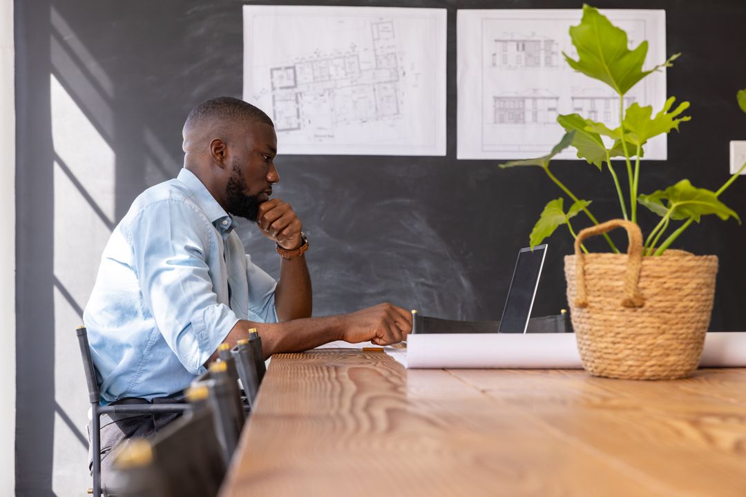 Architect Contemplating Designs in Modern Office Space