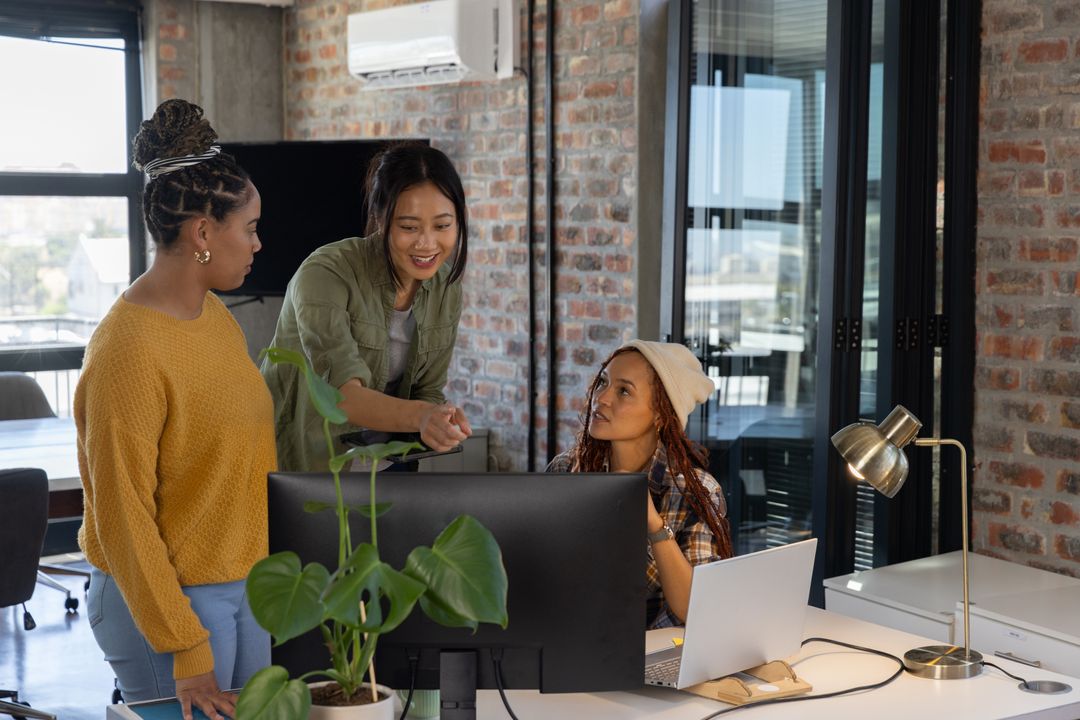 Diverse Team of Female Colleagues Collaborating in Modern Office Environment