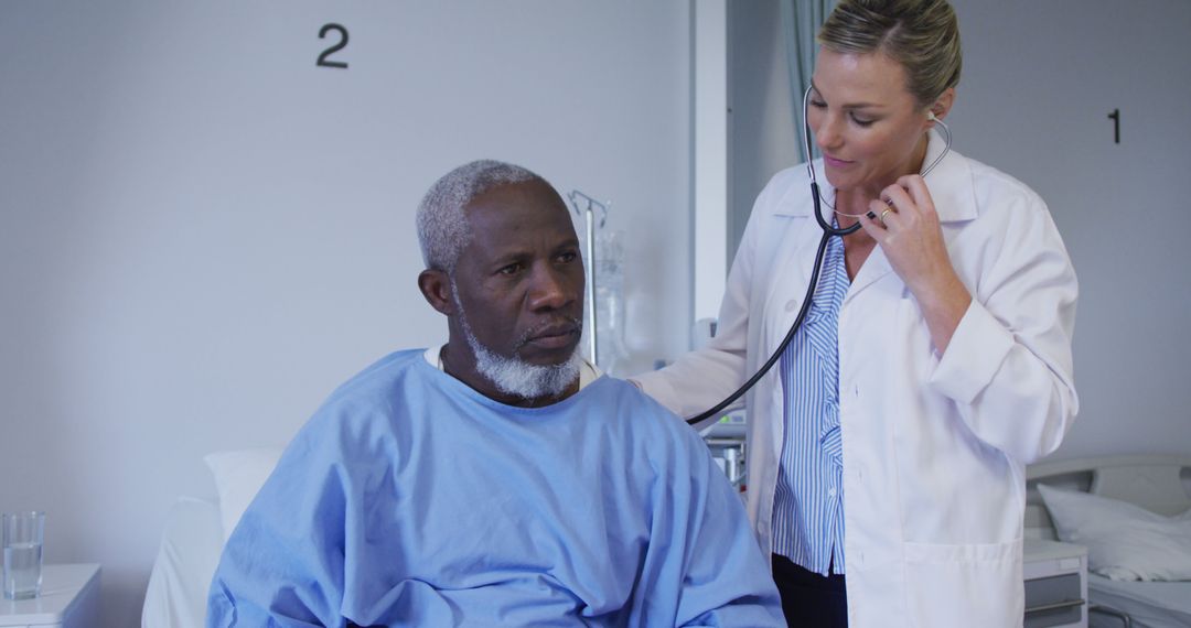 Caucasian female doctor examining african american senior male patient with stethoscope at hospital - Free Images, Stock Photos and Pictures on Pikwizard.com