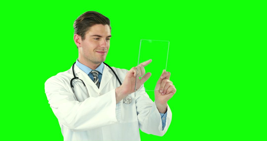 Male Doctor Using Futuristic Transparent Tablet with Green Screen - Free Images, Stock Photos and Pictures on Pikwizard.com