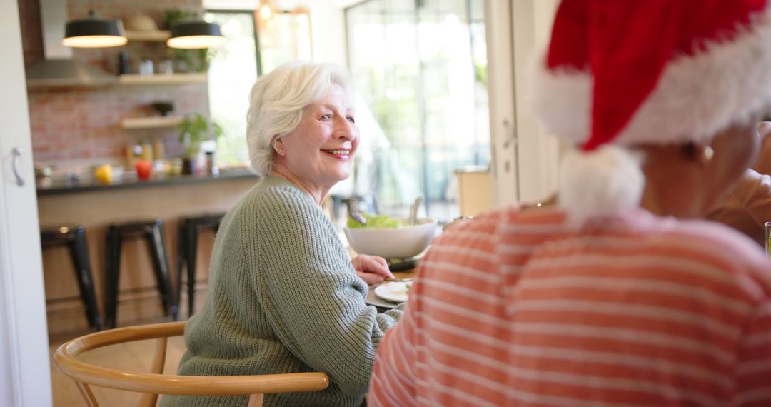 Joyful Senior Woman Enjoying Christmas Gathering with Friends - Free Images, Stock Photos and Pictures on Pikwizard.com