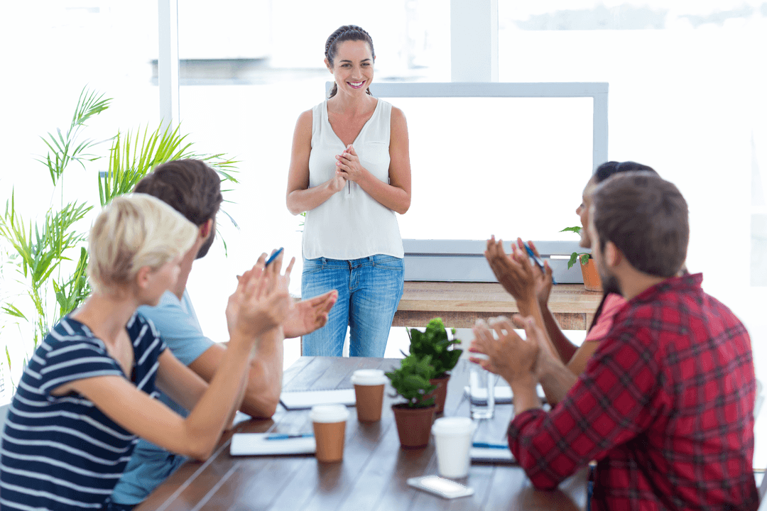 Transparent Team Applauding Leader in Bright Meeting Room
