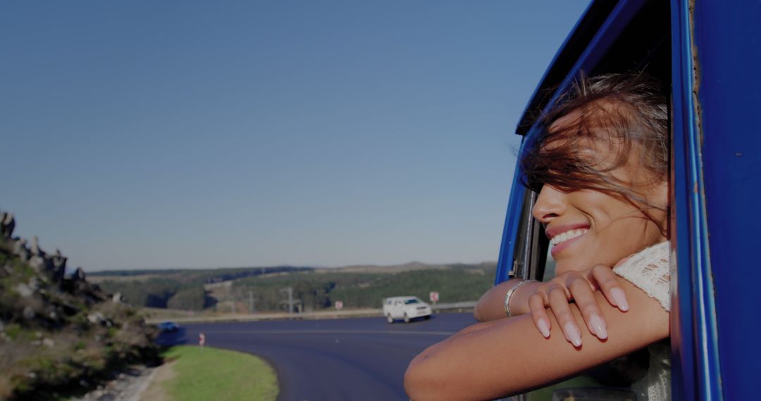 Woman Enjoying Road Trip Leaning Out Car Window - Free Images, Stock Photos and Pictures on Pikwizard.com