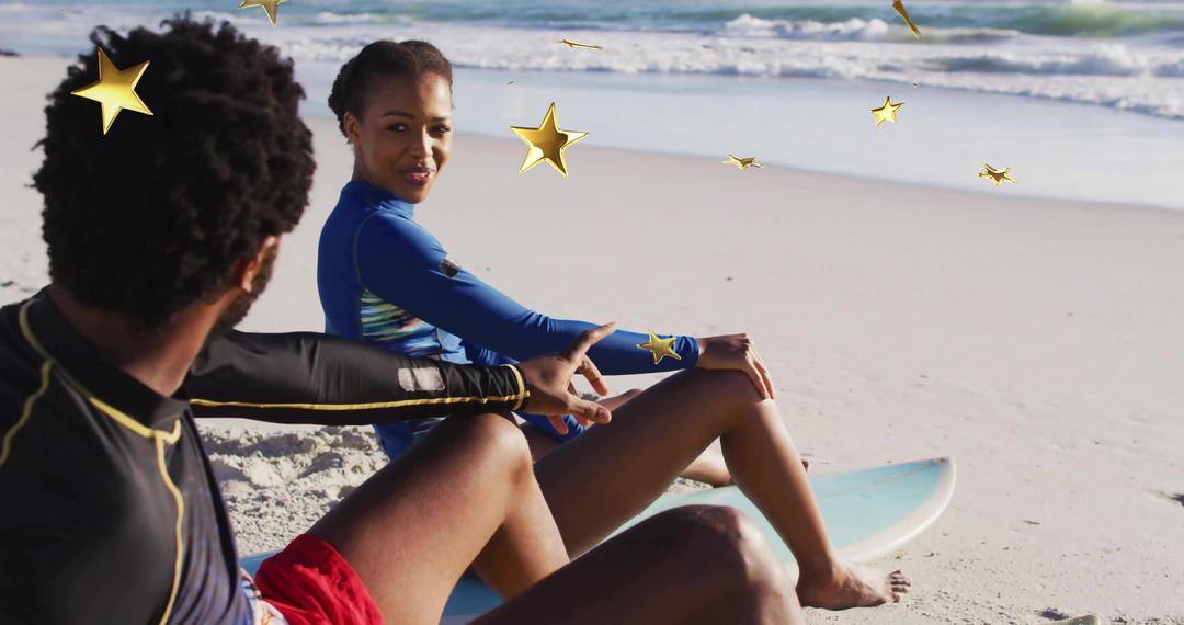 Couple in Rash Guards Relaxing on Beach with Surfboards