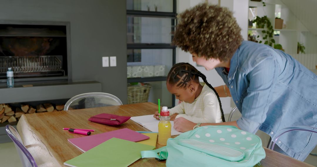 Mother Helping Daughter with Homework in a Cozy Home Environment