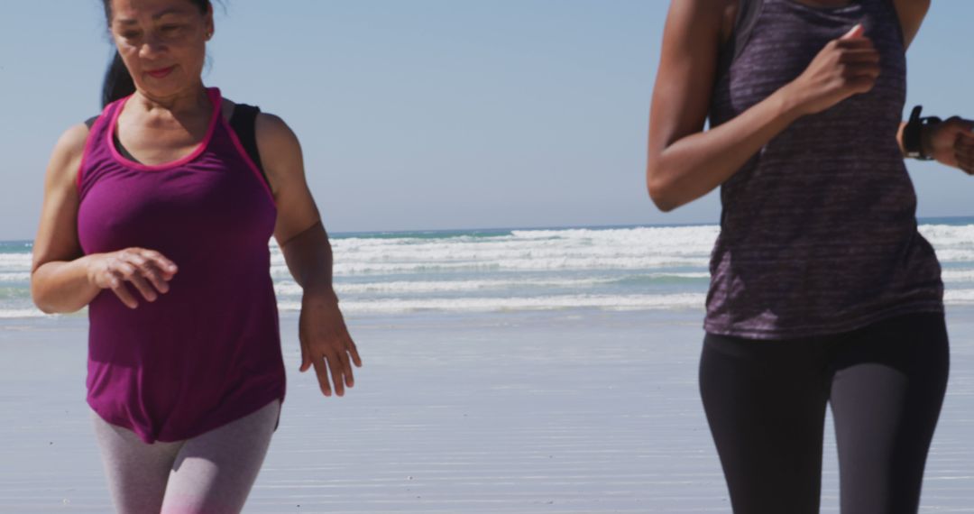 Two Women Jogging Along Beach in Morning Light - Free Images, Stock Photos and Pictures on Pikwizard.com