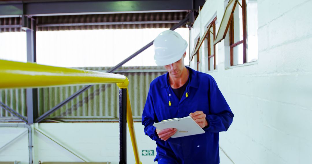 Industrial Worker Conducting Safety Inspection at Factory Site - Free Images, Stock Photos and Pictures on Pikwizard.com