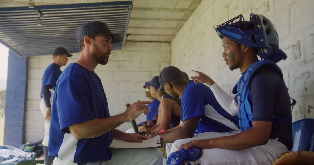 Baseball Coach Giving Instructions to Team Players in Dugout - Free Images, Stock Photos and Pictures on Pikwizard.com