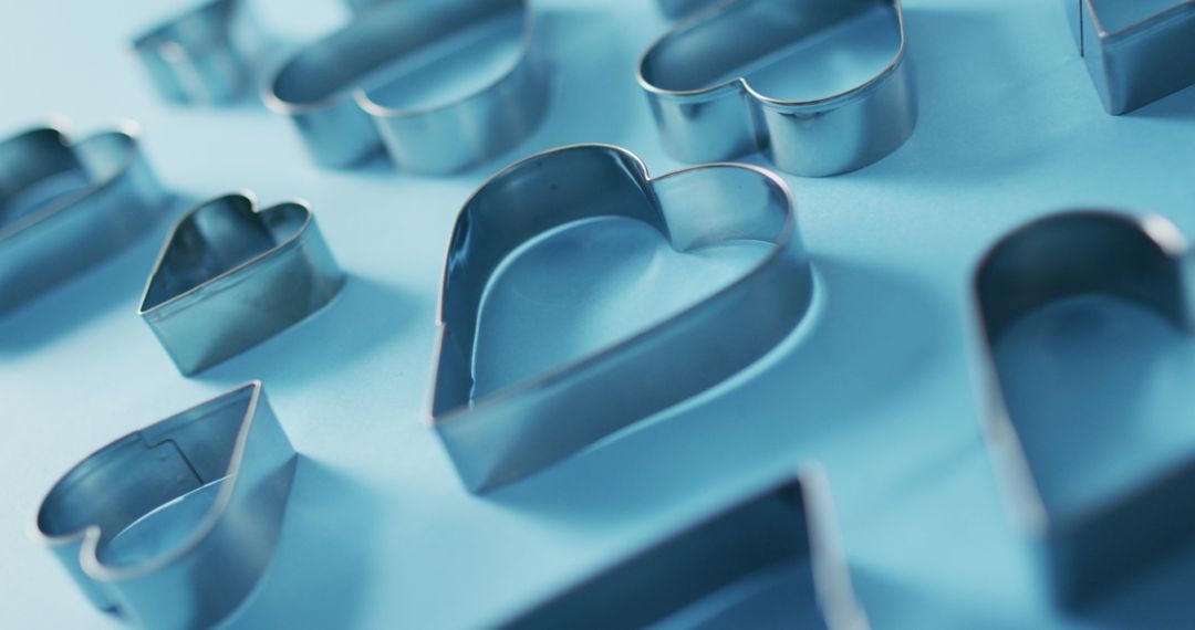 Heart Shaped Cookie Cutters on Blue Background for Valentine's Day Baking